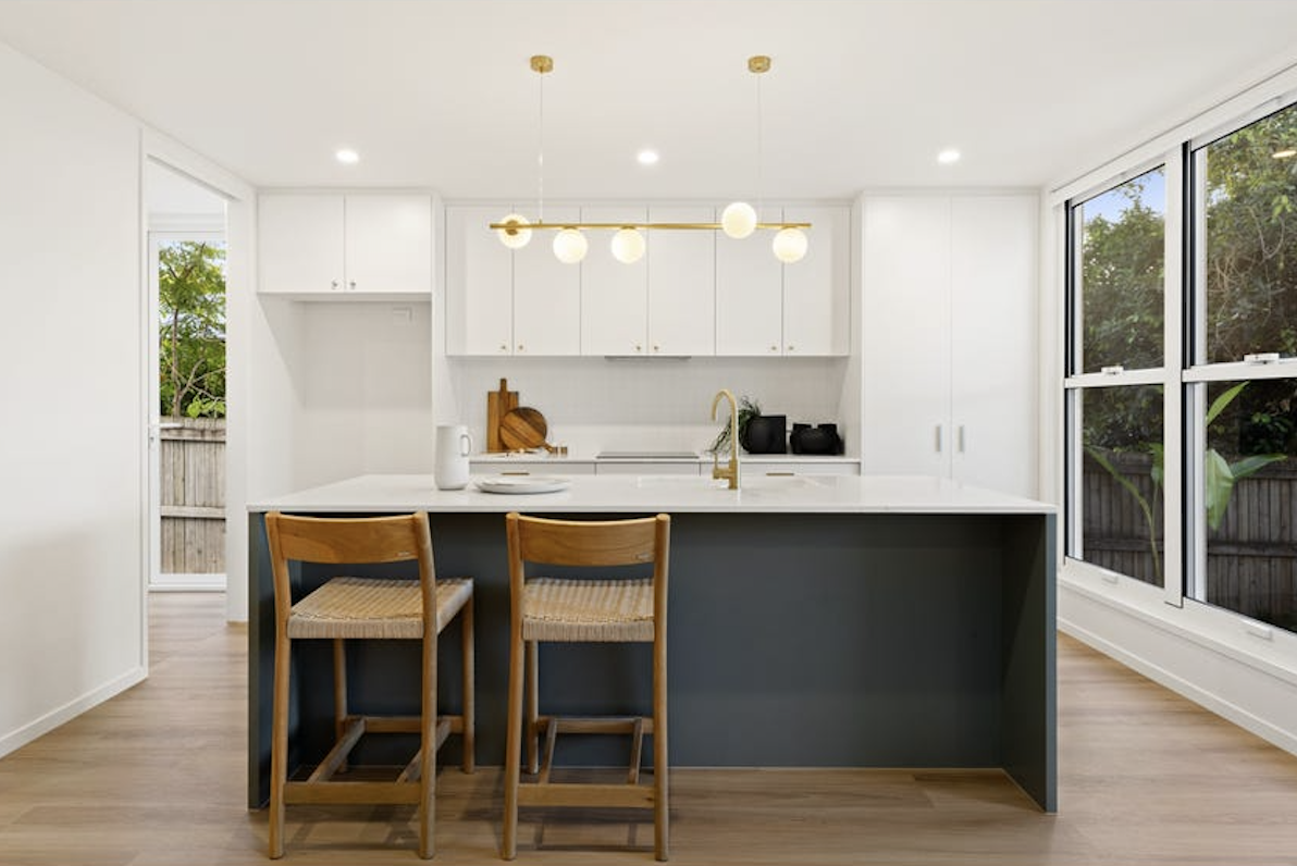 green contemporary kitchen with oak accents, property styling by blink living